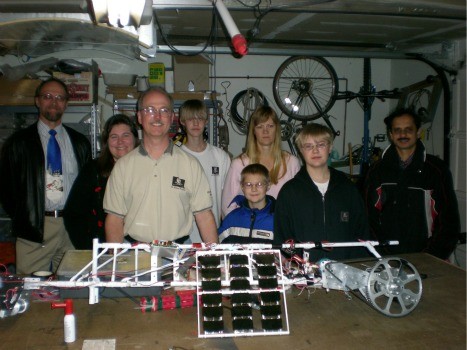 Brian Turner and his motley crew of Space Pirates pose in their garage with their solar-powered climber. 
